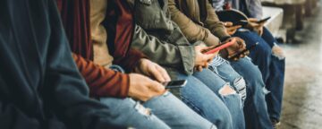 Picture of young people on their phones.