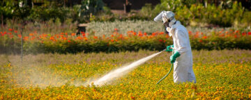 A farm worker spraying weed killer
