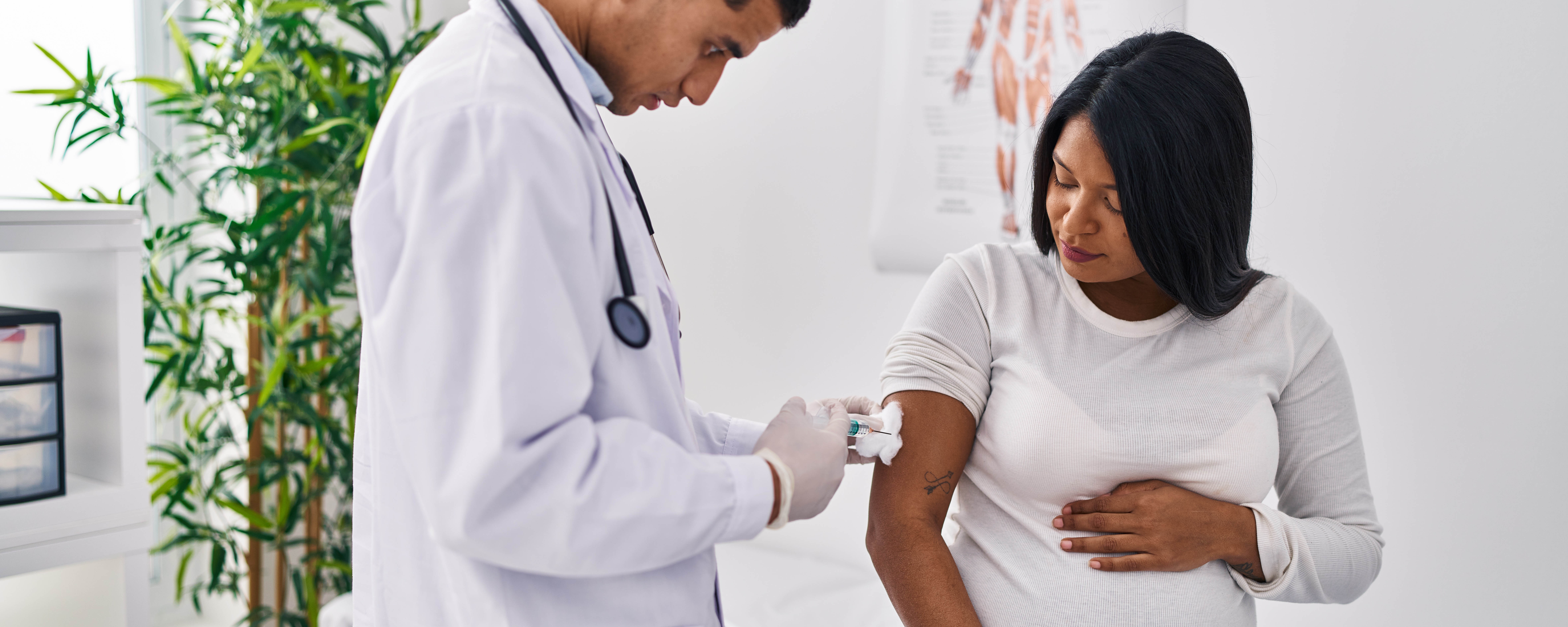 Photo of doctor giving a vaccination to a pregnant woman