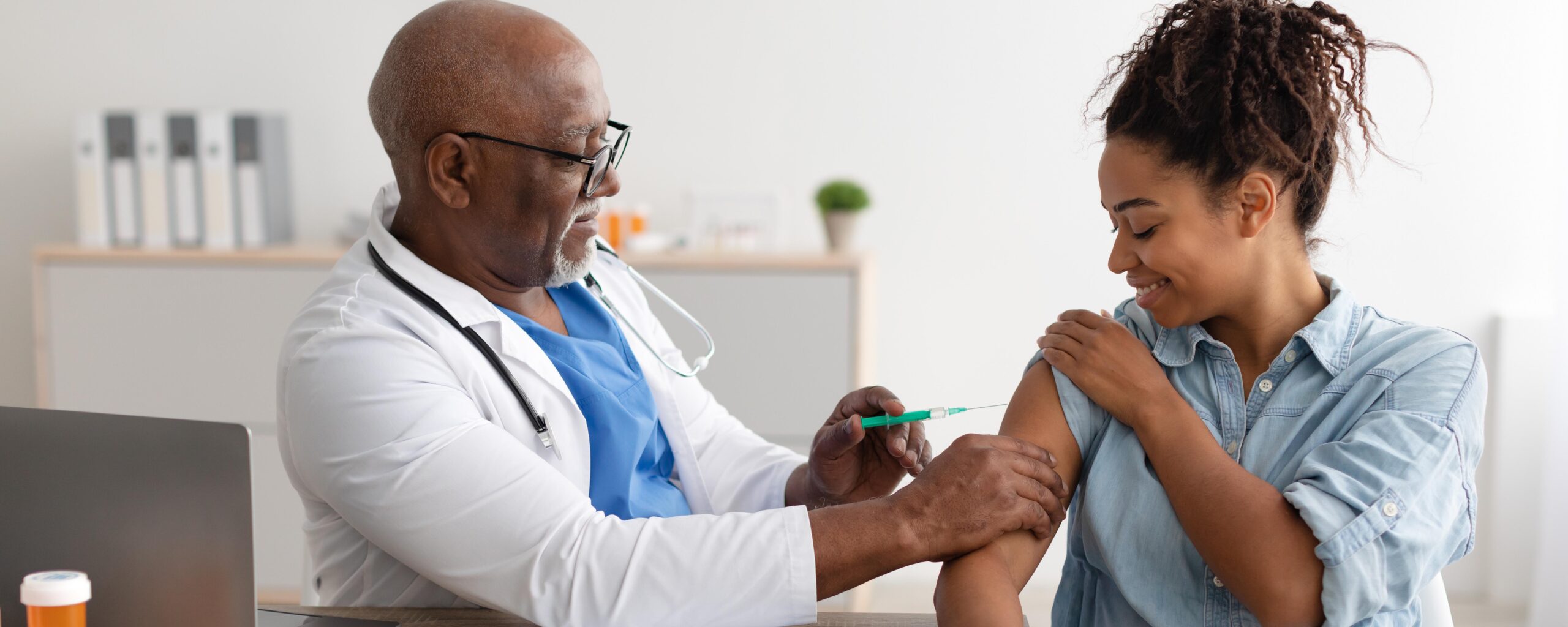 Photo of doctor giving vaccines to woman during pregnancy