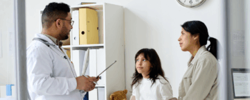 Image of a parent talking to a doctor for release about CDC's shared decision making recommendation regarding vaccinations.