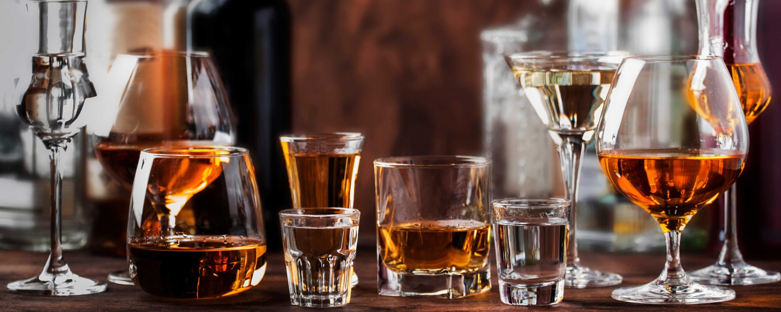 Image of liquor in glasses for story about alcohol consumption and cancer risk
